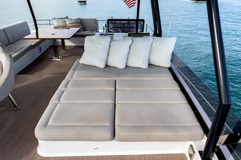 Slide: The Image of Luxurious 2022 Fountaine Pajot MY6 yacht deck with cushioned seating and ocean view. - 12