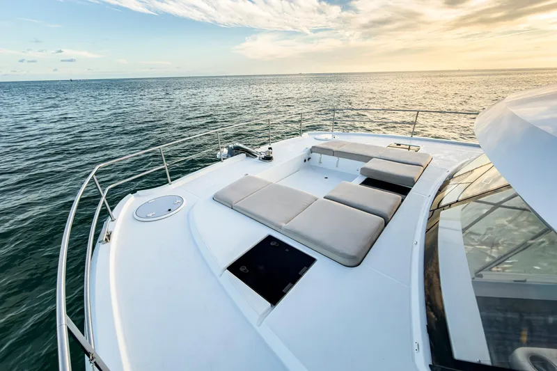 Slide: The Image of 2022 Fountaine Pajot MY6 yacht deck with sun loungers, ocean view at sunset. - 17