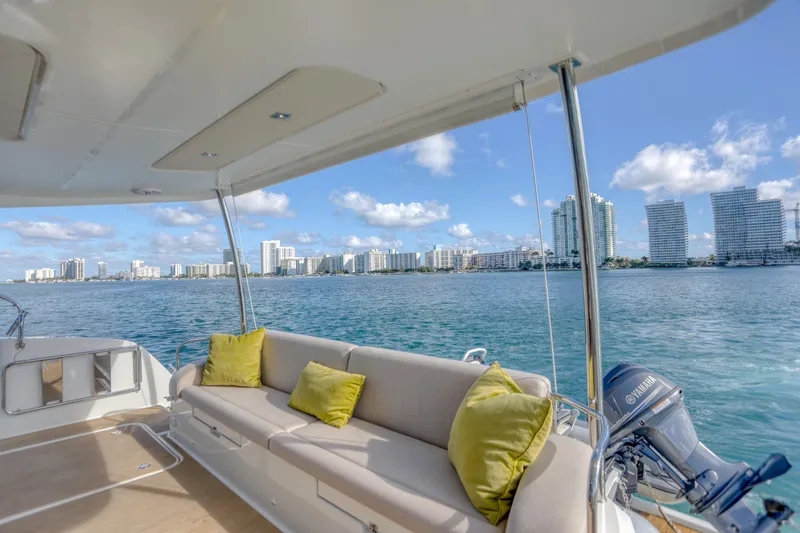 Slide: The Image of 2022 Fountaine Pajot MY6 yacht with city skyline view, featuring a spacious deck and comfortable seating. - 21