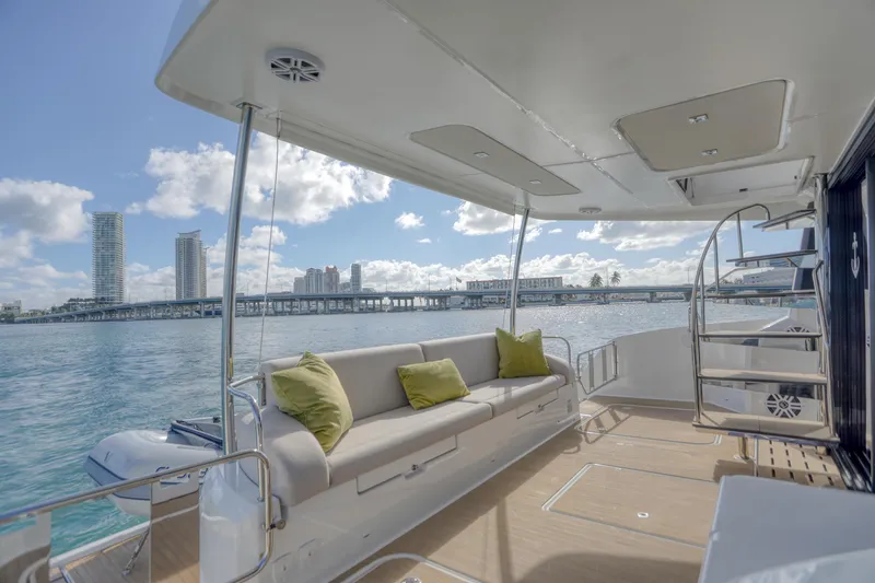 Slide: The Image of Luxurious 2022 Fountaine Pajot MY6 yacht deck with comfortable seating and scenic waterfront view. - 22