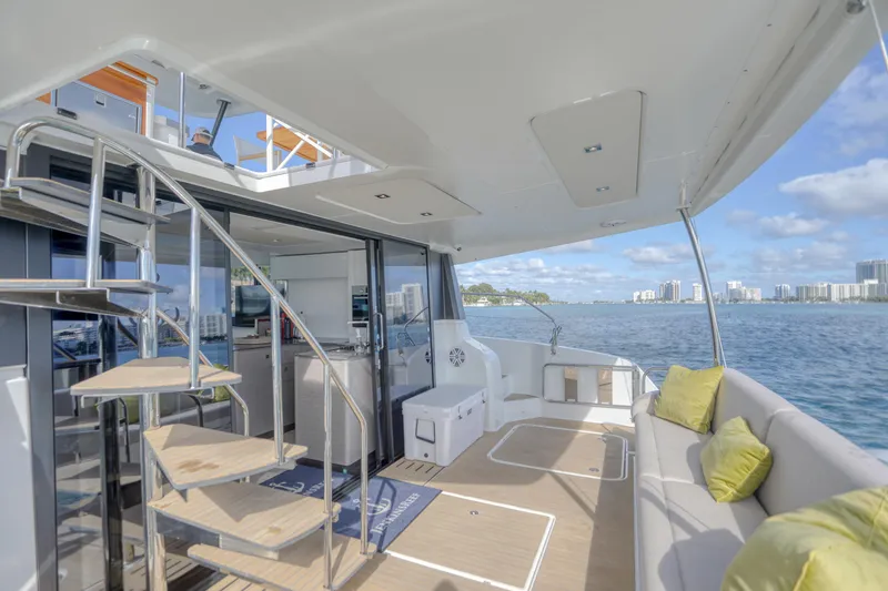 Slide: The Image of 2022 Fountaine Pajot MY6 yacht deck with modern seating and ocean view. - 24