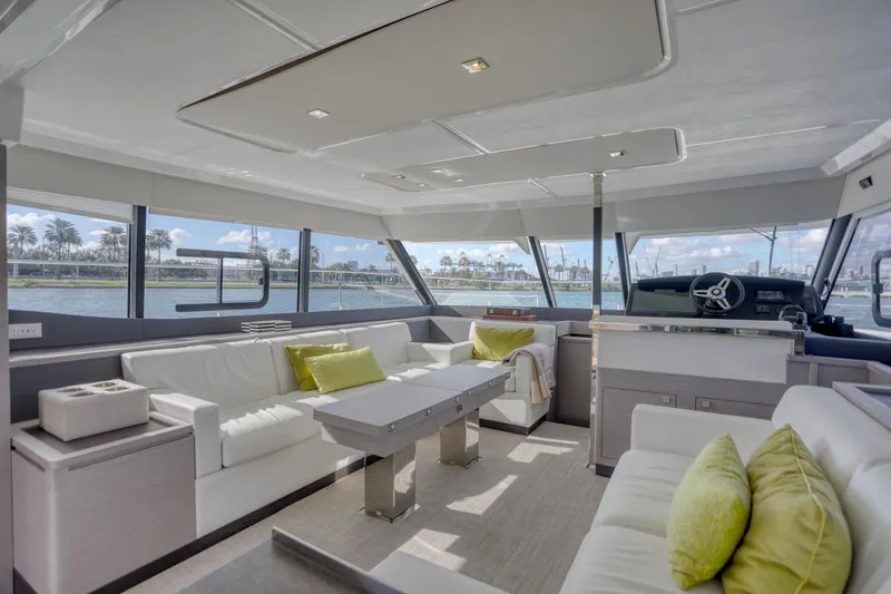 Slide: The Image of Luxurious interior of 2022 Fountaine Pajot MY6 yacht with modern seating and panoramic windows. - 27