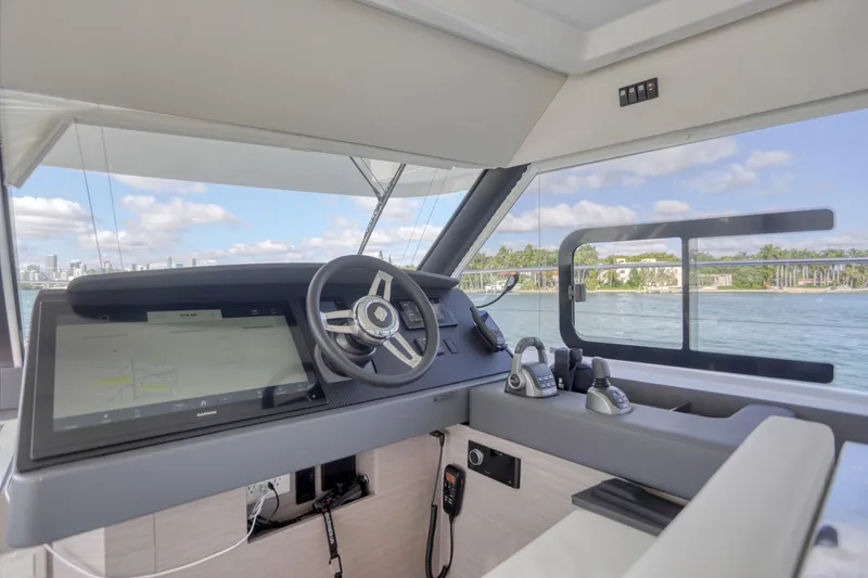 Slide: The Image of 2022 Fountaine Pajot MY6 yacht helm with modern controls and scenic ocean view. - 29