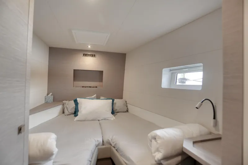 Slide: The Image of Luxurious cabin interior of 2022 Fountaine Pajot MY6 yacht, featuring modern design and cozy bedding. - 40