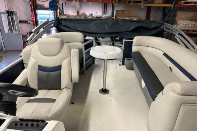 Slide: The Image of 2020 Hurricane FunDeck 236SB OB interior with seating and table. - 11