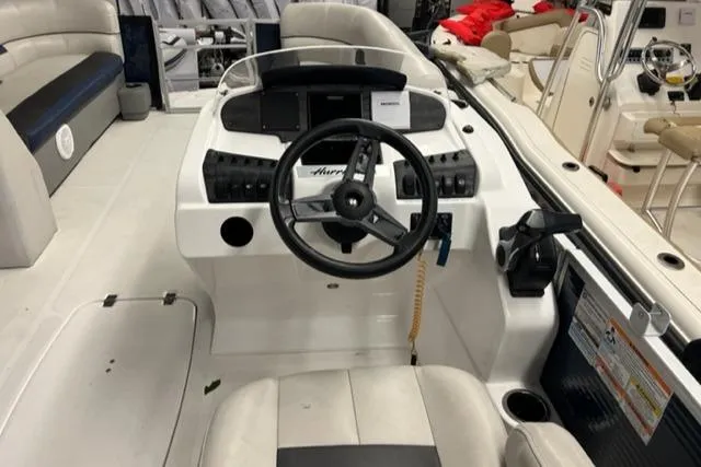 Slide: The Image of 2020 Hurricane FunDeck 236SB OB boat cockpit with steering wheel and control panel. - 12