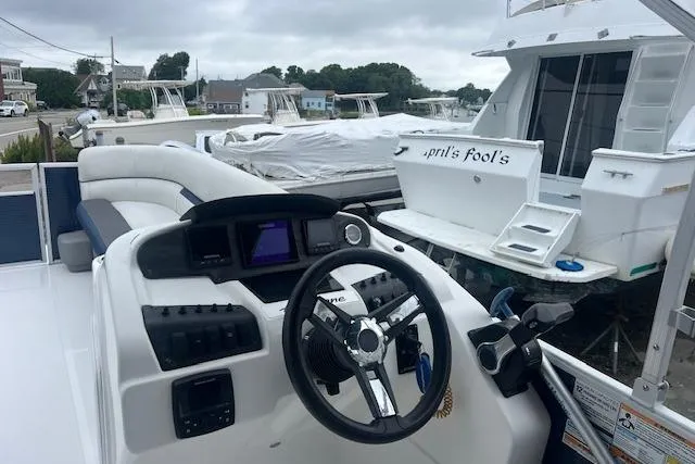 Slide: The Image of 2020 Hurricane FunDeck 236SB OB boat interior with steering wheel and control panel. - 4