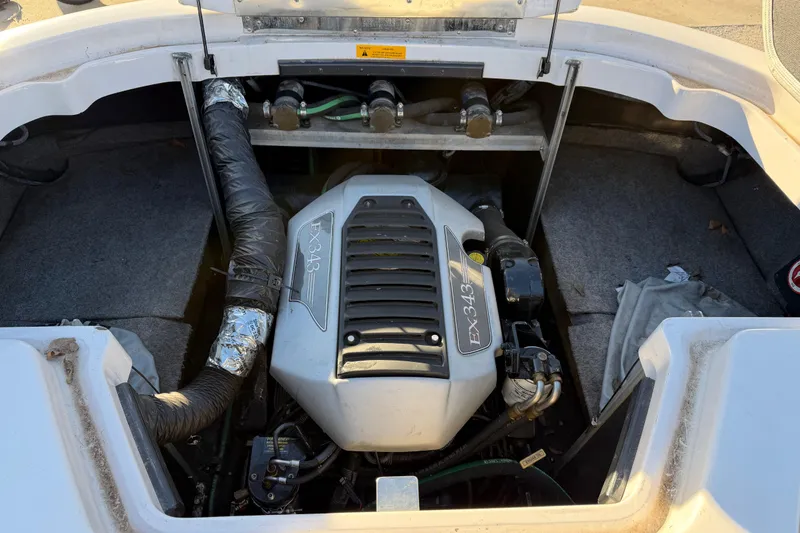 Slide: The Image of 2008 Nautique Super Air Nautique 220 engine compartment with EX343 engine visible. - 12