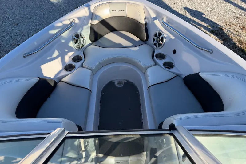Slide: The Image of 2008 Nautique Super Air Nautique 220 boat interior with seating and cup holders. - 8