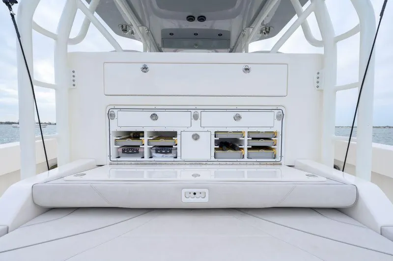 Slide: The Image of 2023 SeaVee 420Z boat storage compartments with organized tackle boxes and drawers. - 13