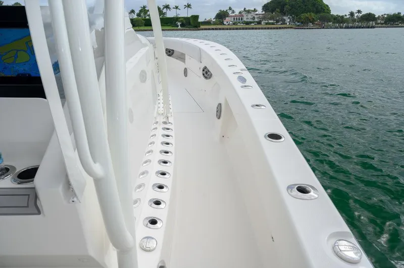 Slide: The Image of 2023 SeaVee 420Z boat deck with rod holders, cruising on calm water. - 23