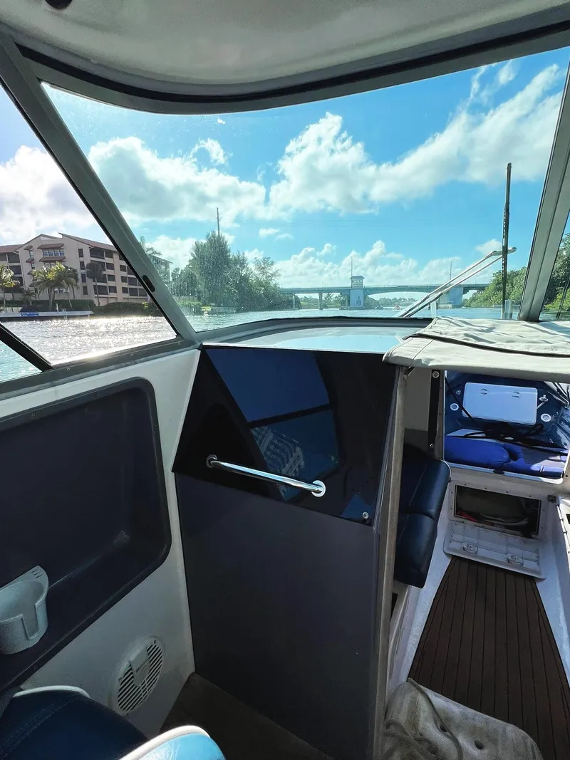 Slide: The Image of Interior view of a 2000 Protector Targa 28 boat with scenic waterway. - 15