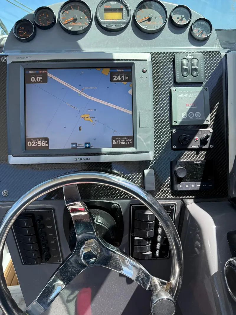 Slide: The Image of Dashboard of a 2000 Protector Targa 28 with navigation system and steering wheel. - 16