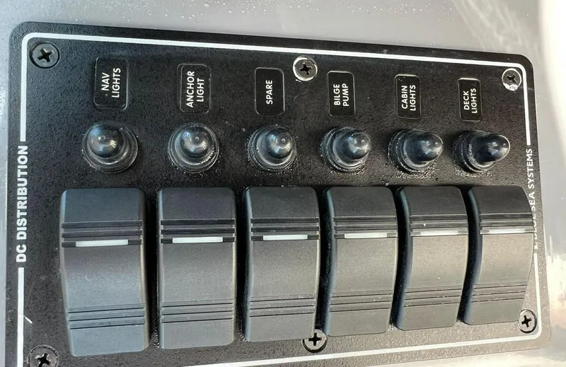 Slide: The Image of Control panel of a 2000 Protector Targa 28 boat with labeled switches. - 20