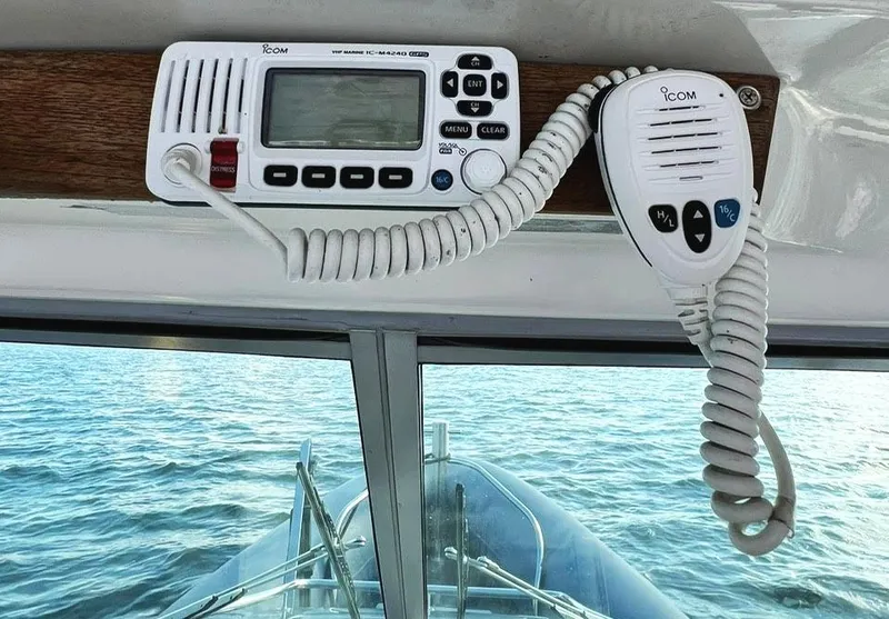Slide: The Image of VHF marine radio on 2000 Protector Targa 28 boat, overlooking calm water. - 23