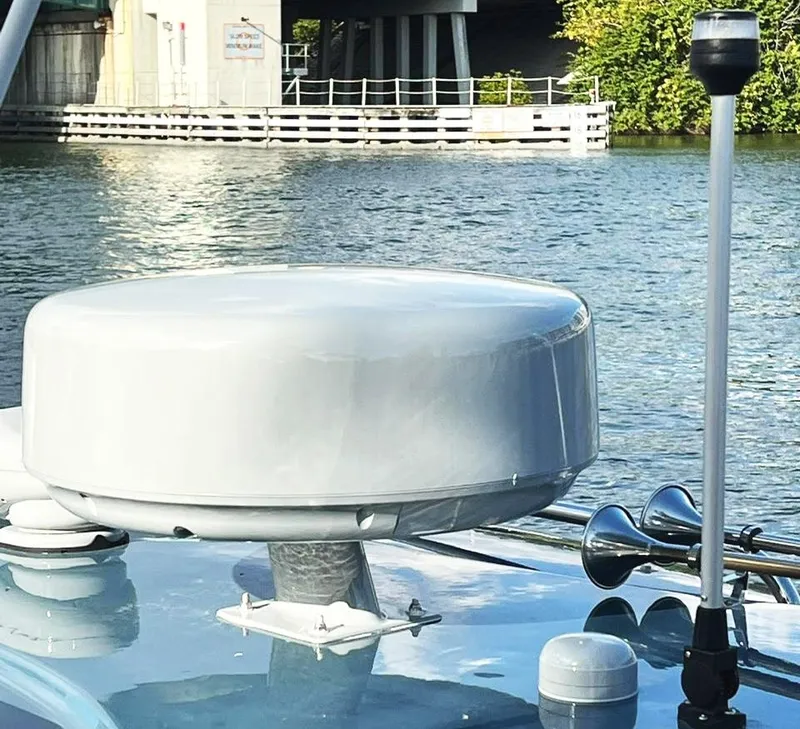 Slide: The Image of Radar dome on a 2000 Protector Targa 28 boat, near a waterfront structure. - 24