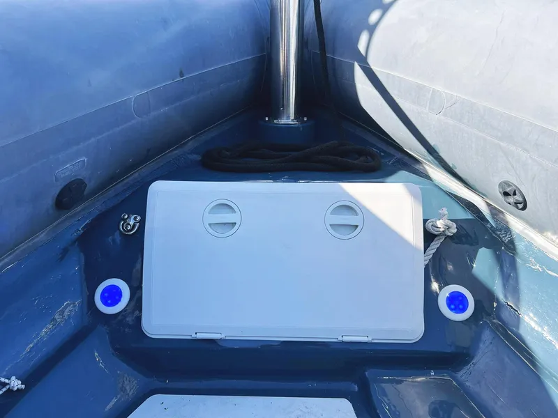 Slide: The Image of Interior of a 2000 Protector Targa 28 boat, featuring storage compartment and nautical equipment. - 28