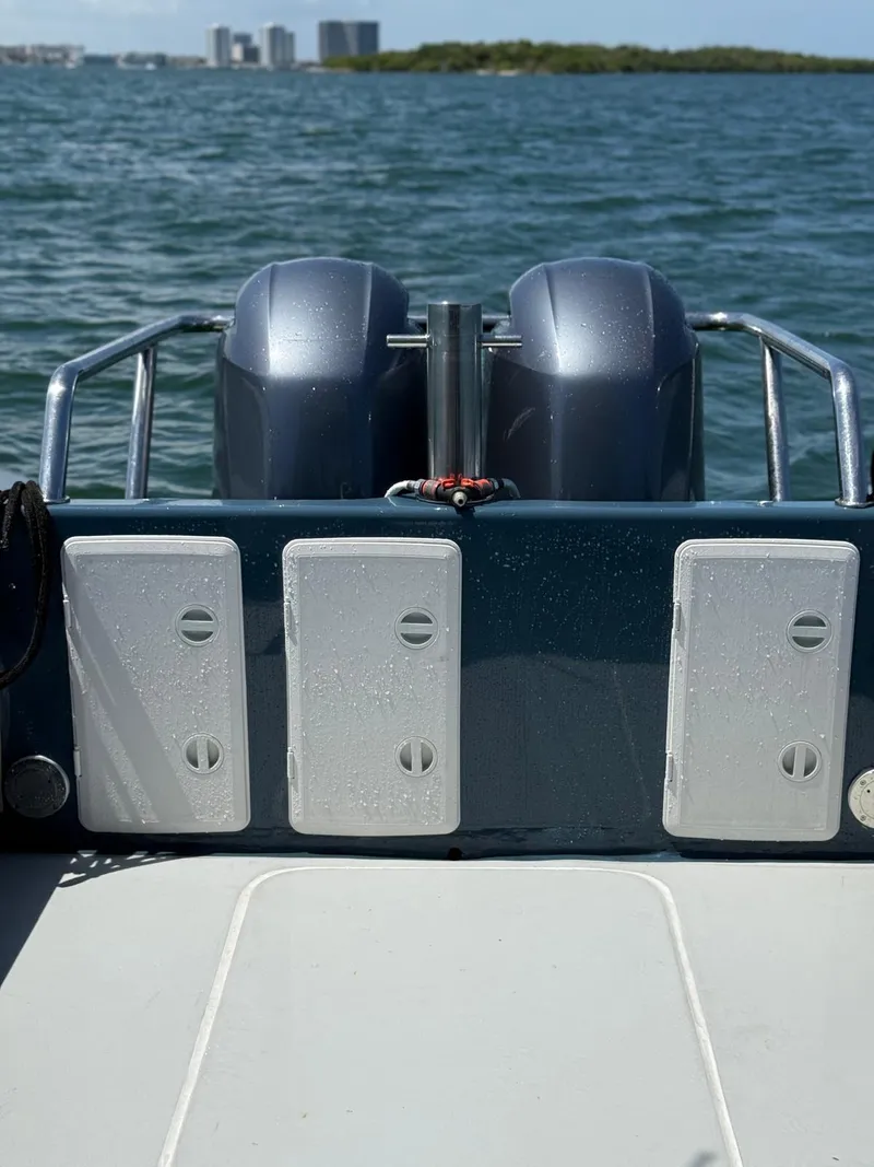 Slide: The Image of Rear view of a 2000 Protector Targa 28 boat with dual engines on the water. - 8