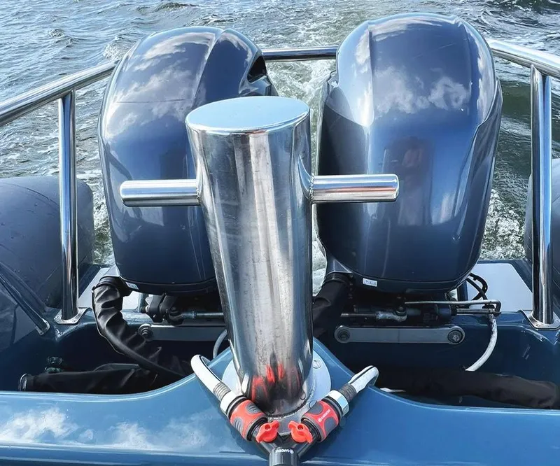 Slide: The Image of Twin outboard motors on a 2000 Protector Targa 28 boat, cruising on water. - 9