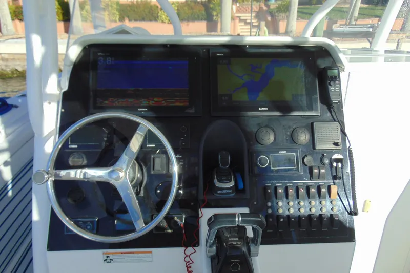 Slide: The Image of Control panel of 2019 Stamas 390 Tarpon boat with steering wheel and navigation screens. - 19