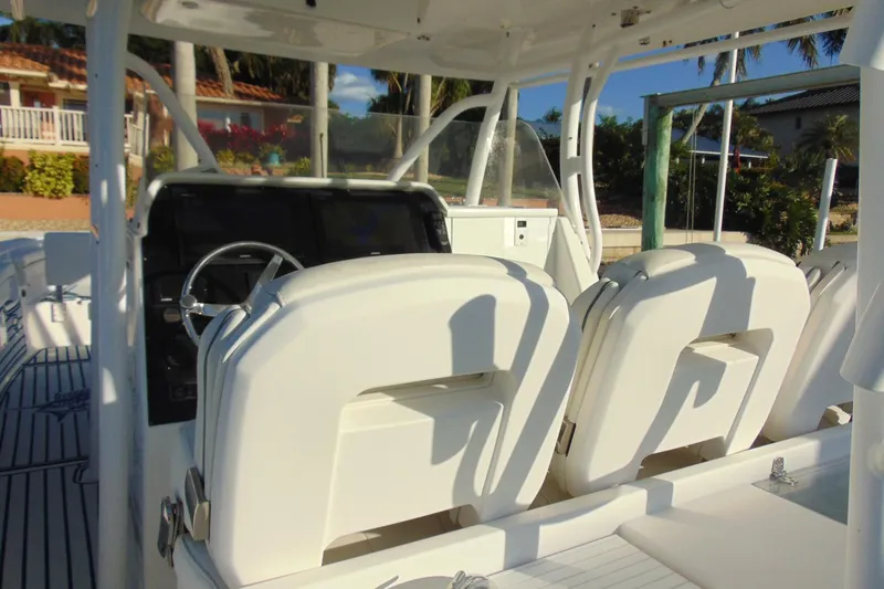 Slide: The Image of 2019 Stamas 390 Tarpon boat interior with white seating and steering console. - 21