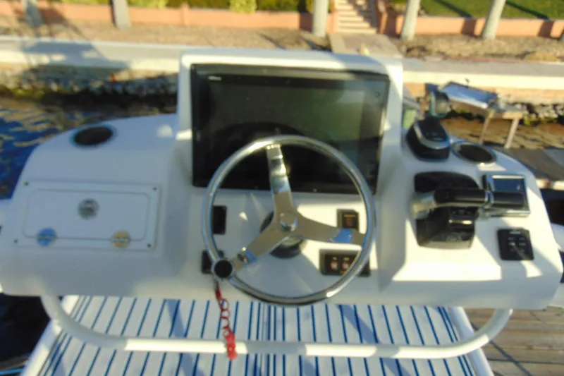Slide: The Image of Helm of 2019 Stamas 390 Tarpon boat with steering wheel and controls. - 27
