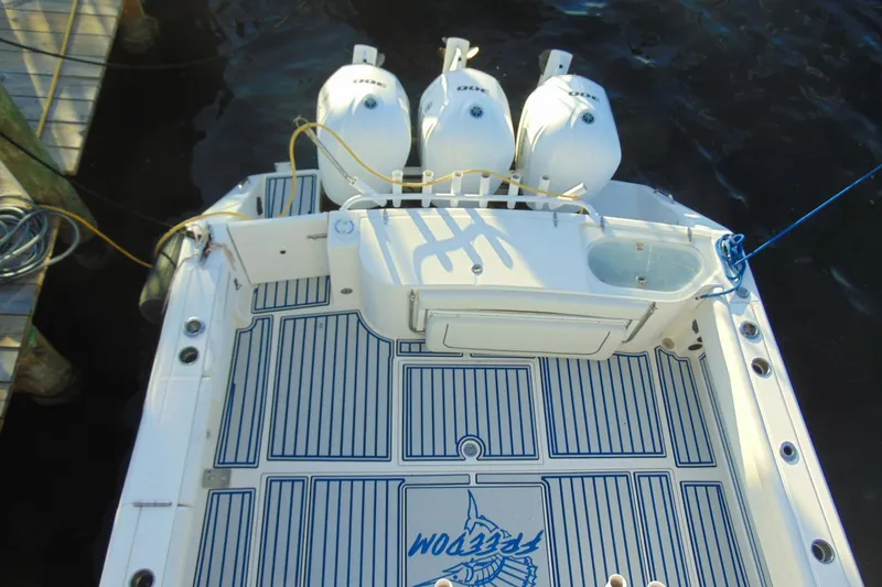 Slide: The Image of 2019 Stamas 390 Tarpon boat with triple outboard engines, docked on water. - 28