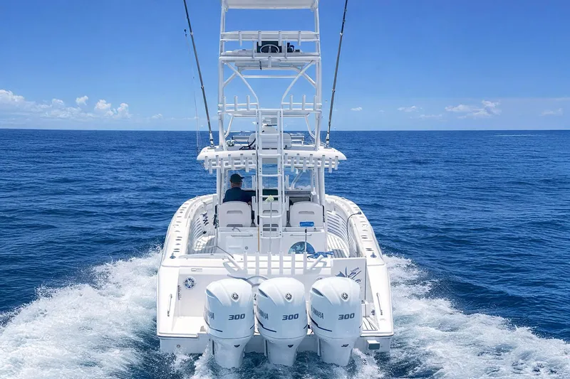 Slide: The Image of 2019 Stamas 390 Tarpon boat cruising on open ocean with triple Yamaha engines. - 3