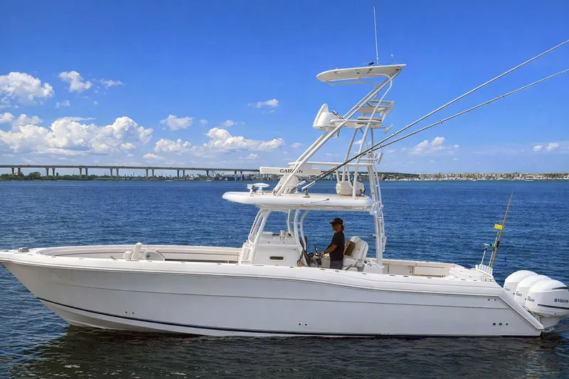 Slide: The Image of 2019 Stamas 390 Tarpon boat on calm water under a clear blue sky. - 5