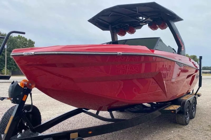 Slide: The Image of 2026 Tigé Z3 boat in vibrant red on a trailer, showcasing sleek design. - 2