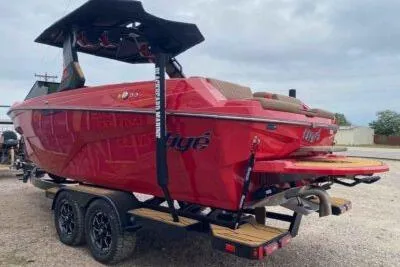 Slide: The Image of 2026 Tigé Z3 boat in vibrant red on a trailer, showcasing sleek design and modern features. - 3