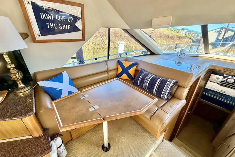 Slide: The Image of Interior of 2002 Bayliner 3988 Command Bridge Motoryacht with cozy seating and nautical decor. - 11