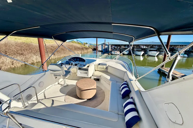 Slide: The Image of 2002 Bayliner 3988 Command Bridge Motoryacht interior with helm, seating, and marina view. - 14