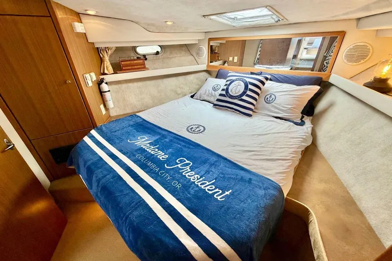 Slide: The Image of Luxurious bedroom in 2002 Bayliner 3988 Command Bridge Motoryacht with nautical decor. - 16