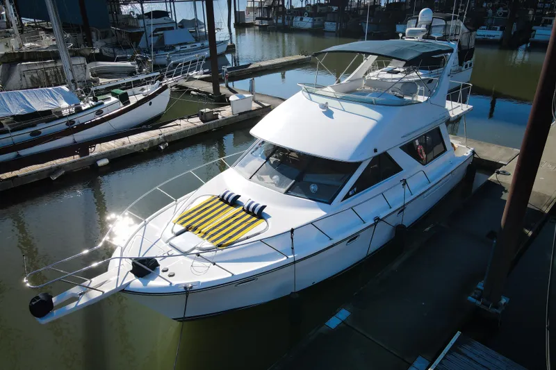 Slide: The Image of 2002 Bayliner 3988 Command Bridge Motoryacht docked at marina, sunny day. - 2