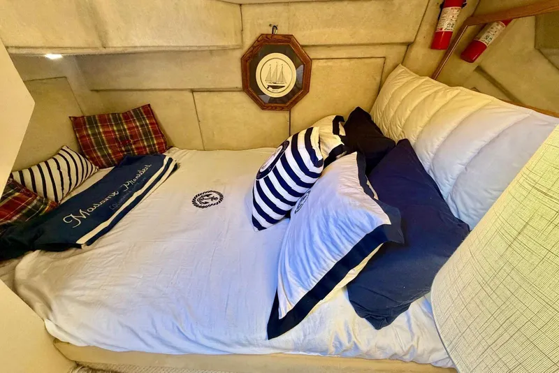 Slide: The Image of Cozy cabin interior of 2002 Bayliner 3988 Command Bridge Motoryacht with nautical-themed bedding. - 20