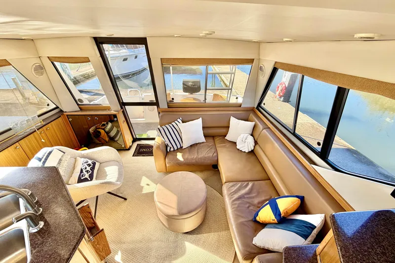 Slide: The Image of Luxurious interior of 2002 Bayliner 3988 Command Bridge Motoryacht with plush seating and scenic views. - 5