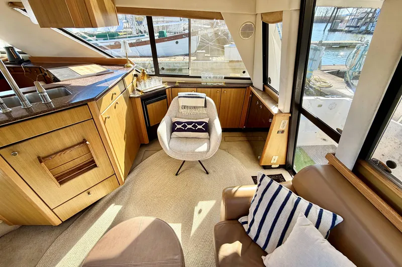 Slide: The Image of Interior of 2002 Bayliner 3988 Command Bridge Motoryacht with modern furnishings and kitchen. - 6
