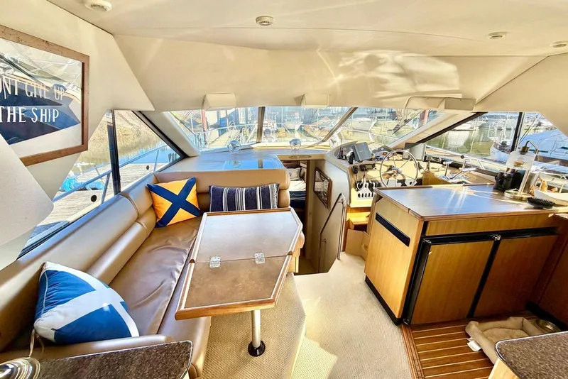 Slide: The Image of Interior of 2002 Bayliner 3988 Command Bridge Motoryacht with seating, helm, and nautical decor. - 9