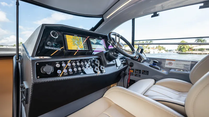 Slide: The Image of Interior view of 2026 Hanover 415 boat cockpit with modern controls. - 49