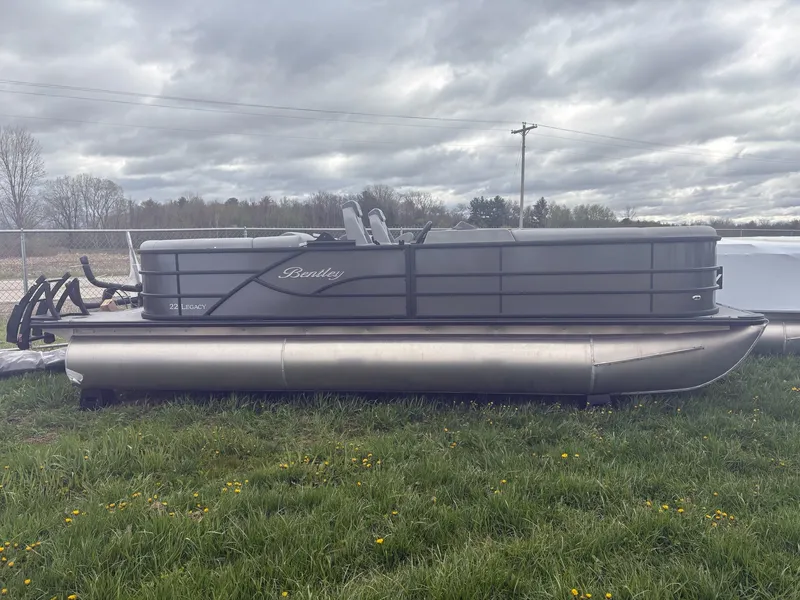Slide: The Image of 2026 Bentley Pontoons LEGACY 223 NAVIGATOR TRI-TOON on grassy field. - 2