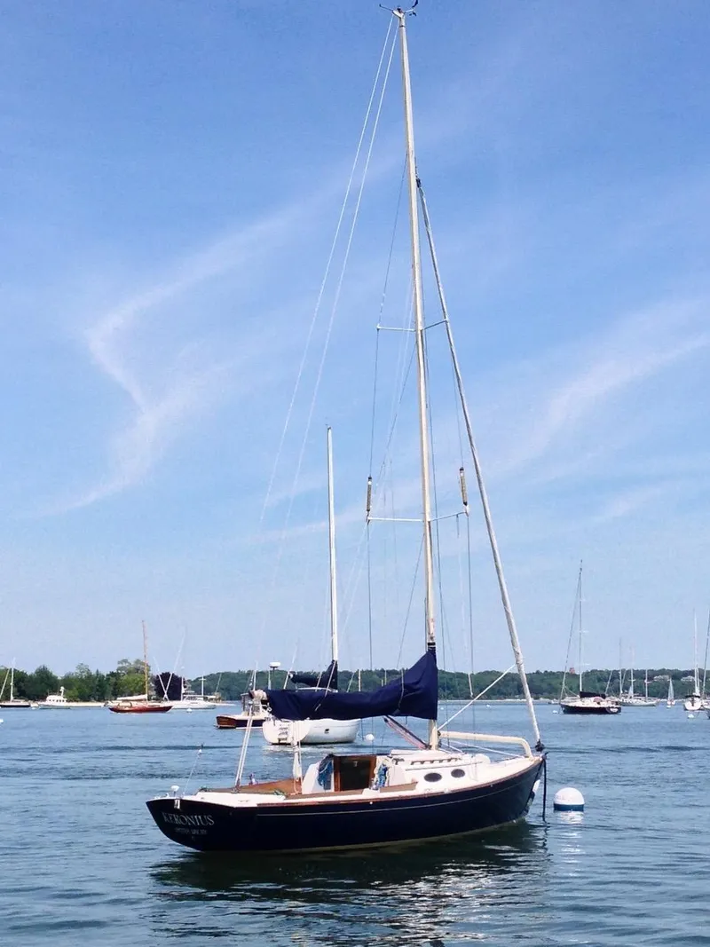 Slide: The Image of 2004 Alerion Express 28 sailboat on calm water under clear blue sky. - 2