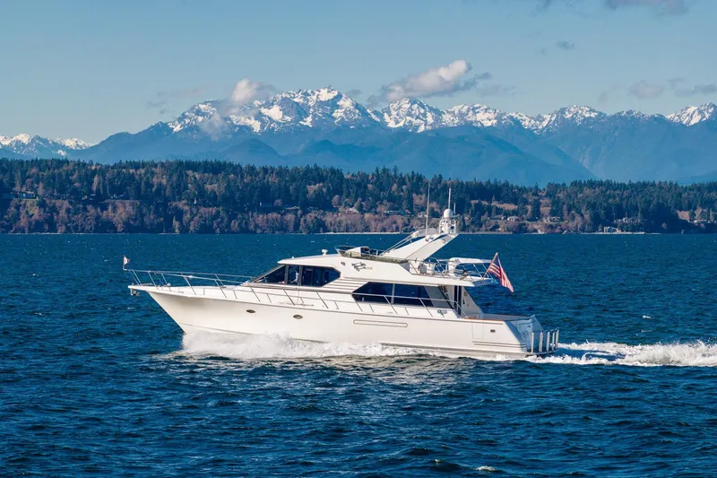 Slide: The Image of 1998 West Bay 58 Sonship Pilothouse MY cruising on blue water with snowy mountains in background. - 10