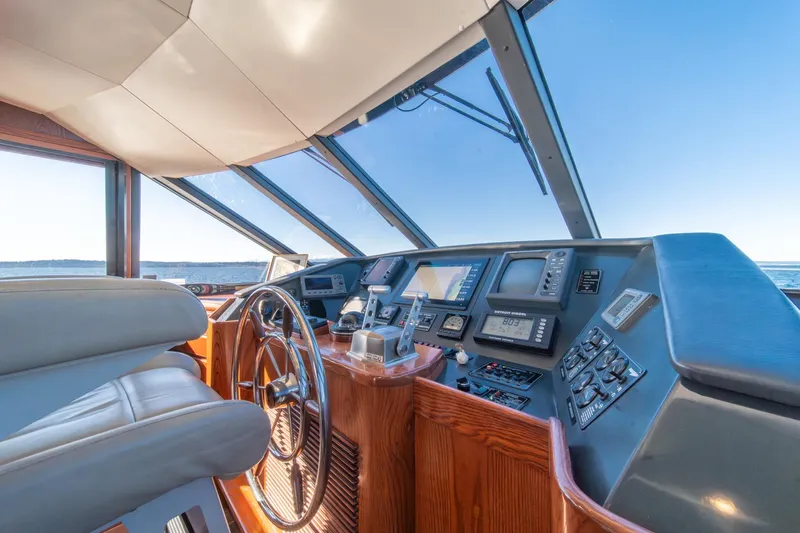 Slide: The Image of Pilothouse interior of 1998 West Bay 58 Sonship, featuring navigation controls and panoramic windows. - 28