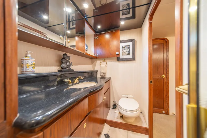 Slide: The Image of Luxurious bathroom in 1998 West Bay 58 Sonship Pilothouse MY yacht, featuring elegant wood cabinetry. - 34