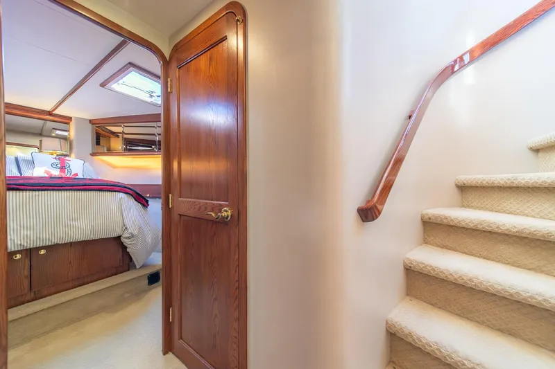 Slide: The Image of Interior of 1998 West Bay 58 Sonship Pilothouse MY, featuring bedroom and carpeted stairs. - 39