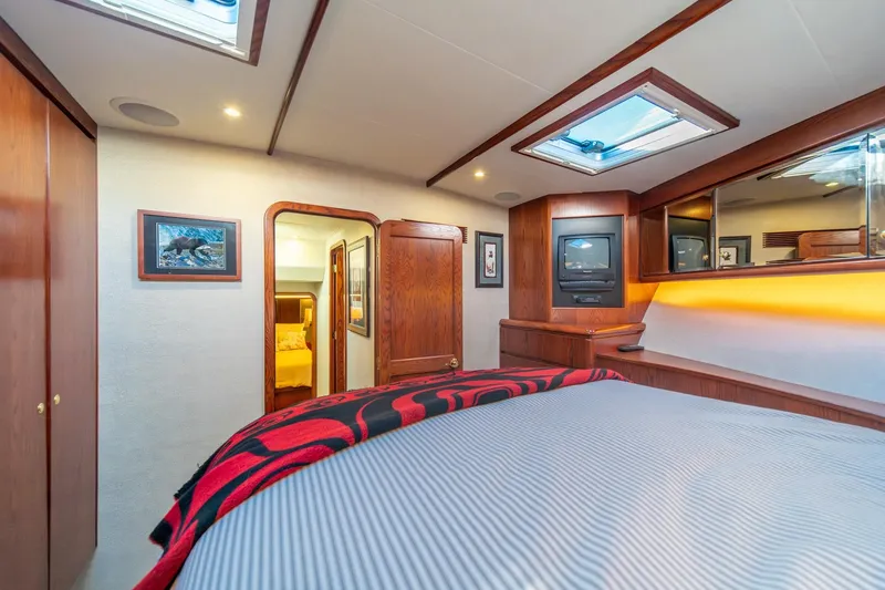 Slide: The Image of Luxurious 1998 West Bay 58 Sonship Pilothouse MY bedroom with wood accents and skylight. - 41