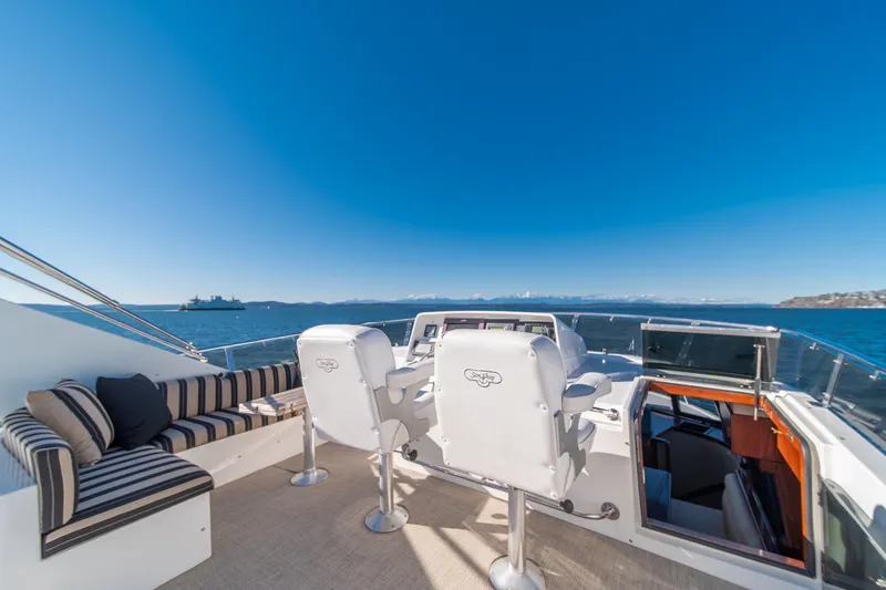 Slide: The Image of 1998 West Bay 58 Sonship Pilothouse MY yacht deck with seating and ocean view. - 49