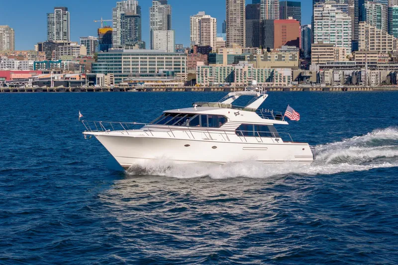 Slide: The Image of 1998 West Bay 58 Sonship Pilothouse MY cruising near city skyline. - 5