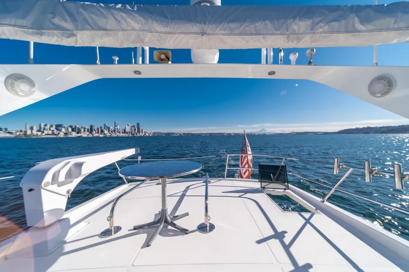 Slide: The Image of 1998 West Bay 58 Sonship Pilothouse MY on water, city skyline in background. - 50
